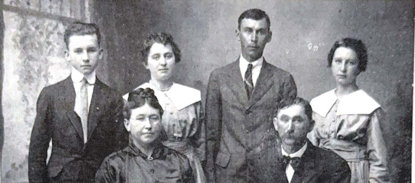 Family portrait showing six people in formal poses