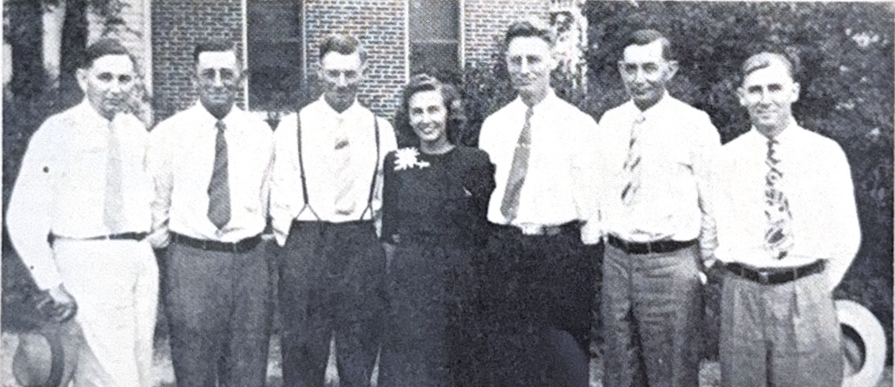 Group photograph of seven men in suits and ties